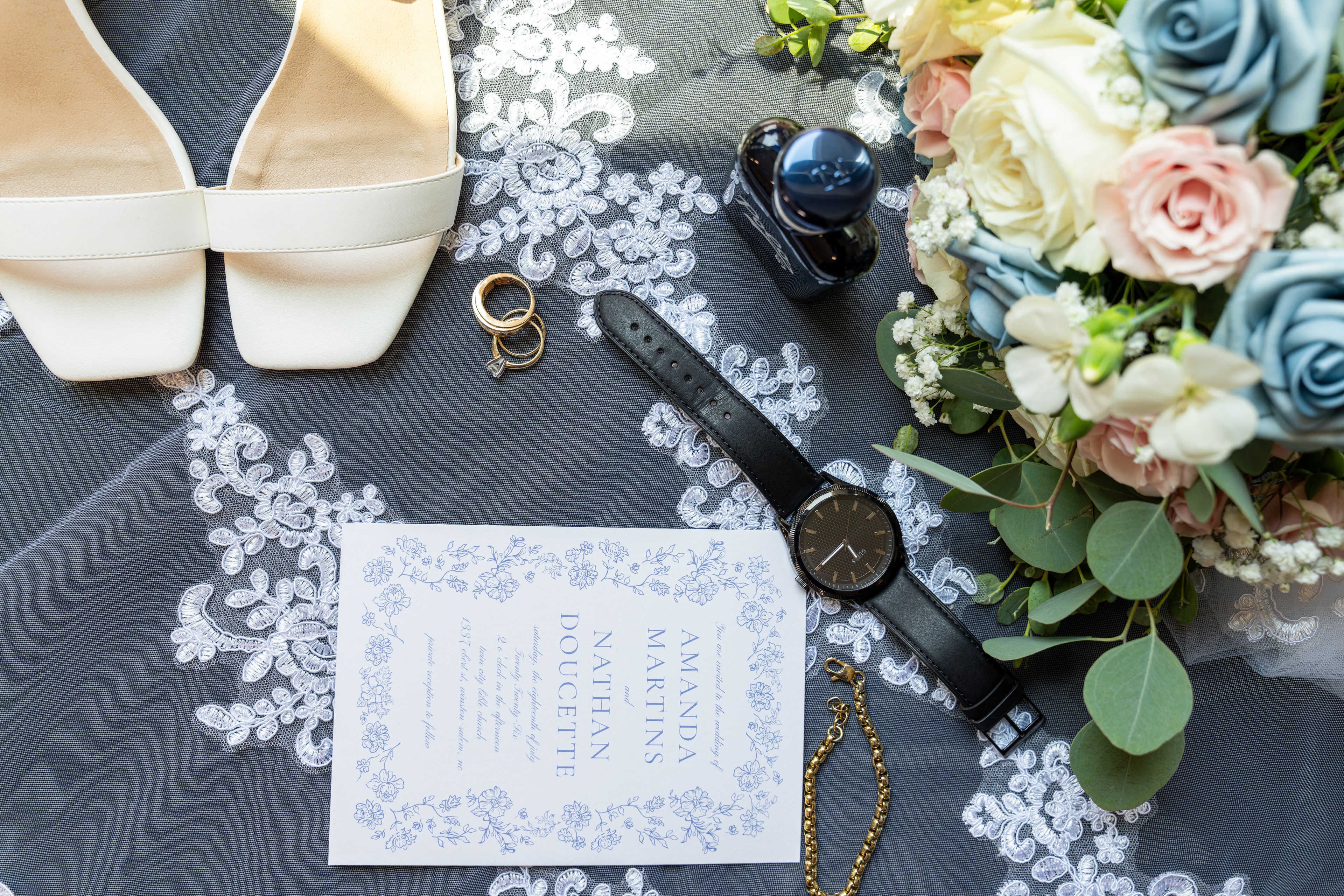 Wedding flat lay — invitation, rings, bouquet, and details