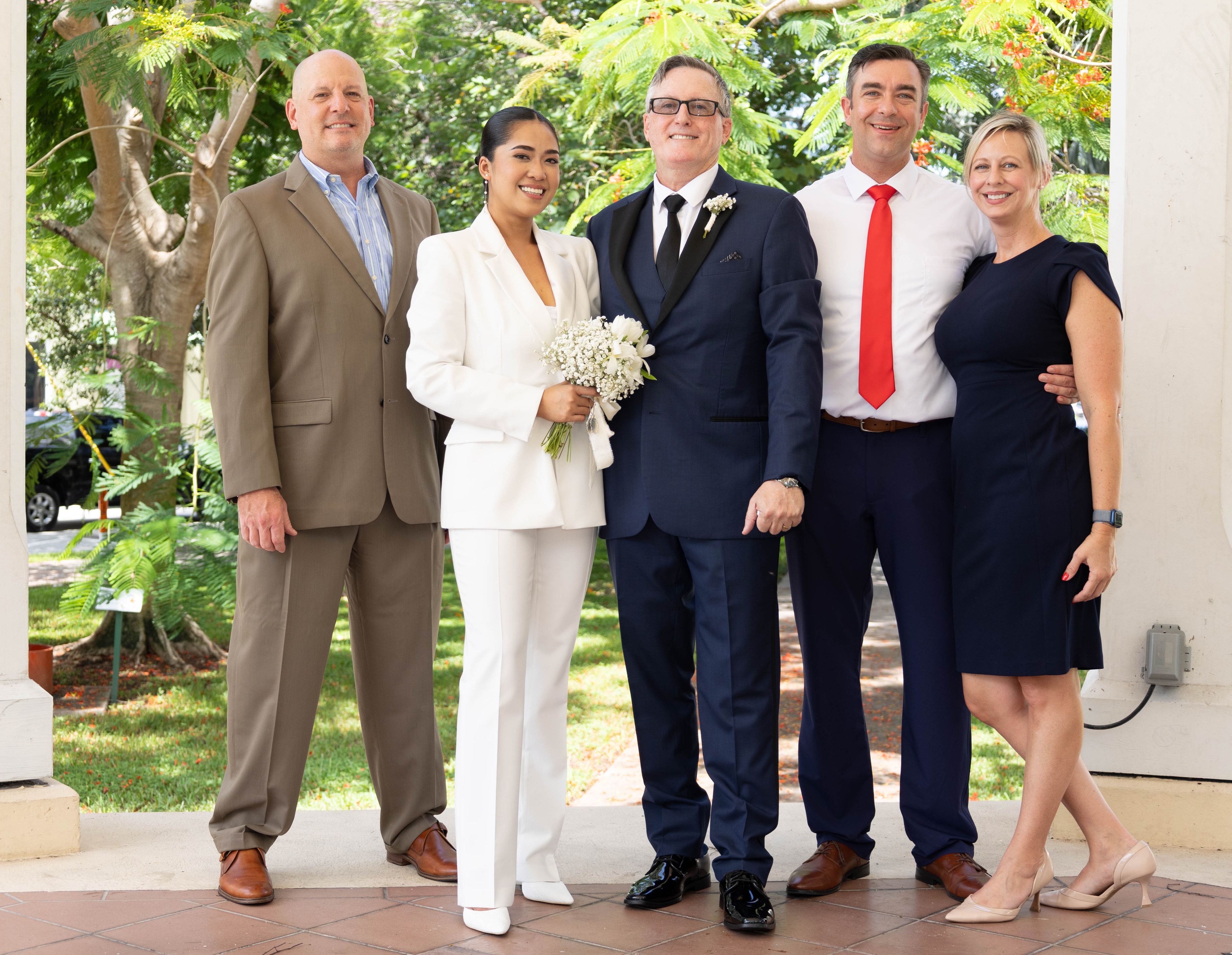 Wedding party group portrait with couple at center
