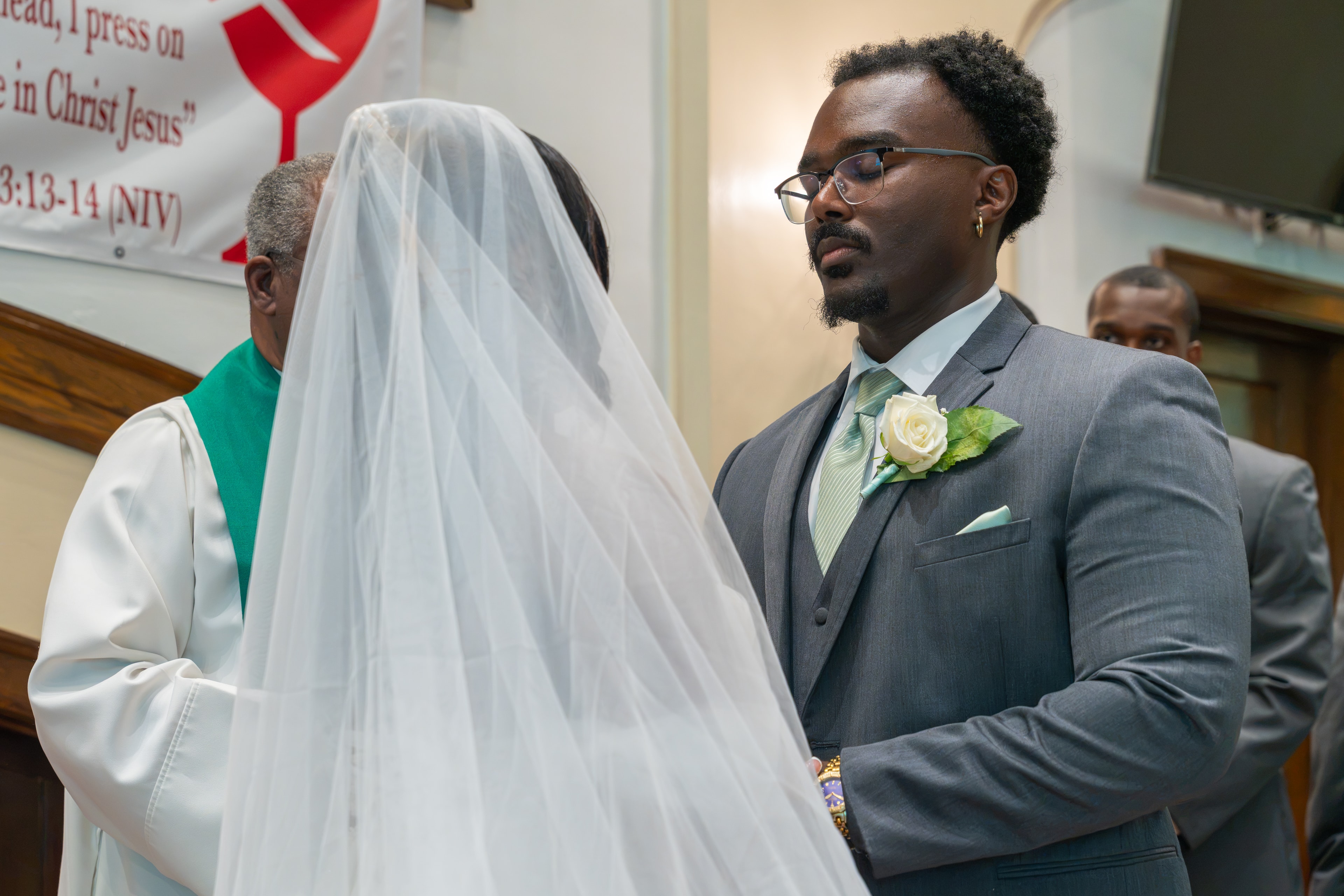 Groom watching bride walk down the aisle