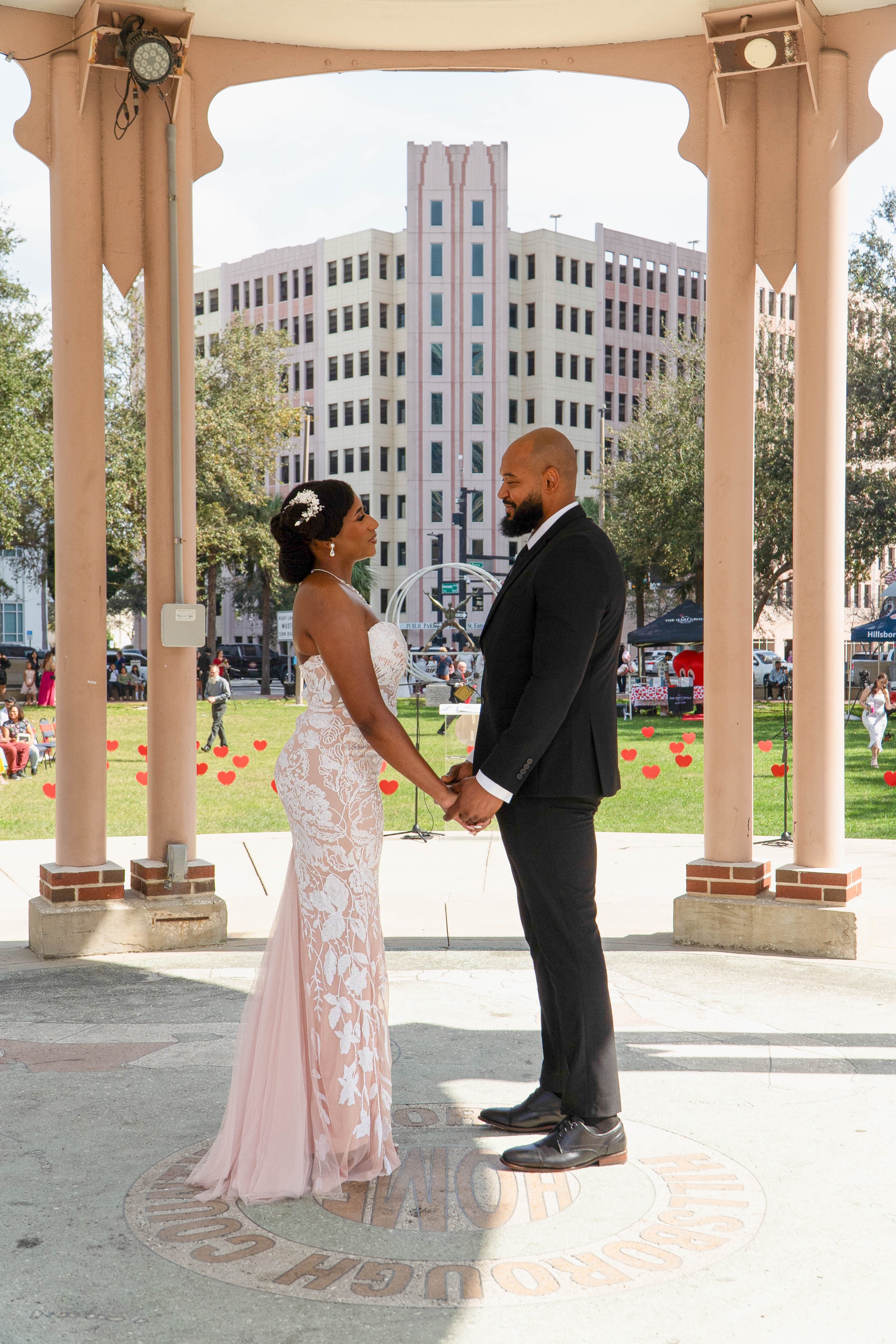 Couple holding hands in gazebo ceremony