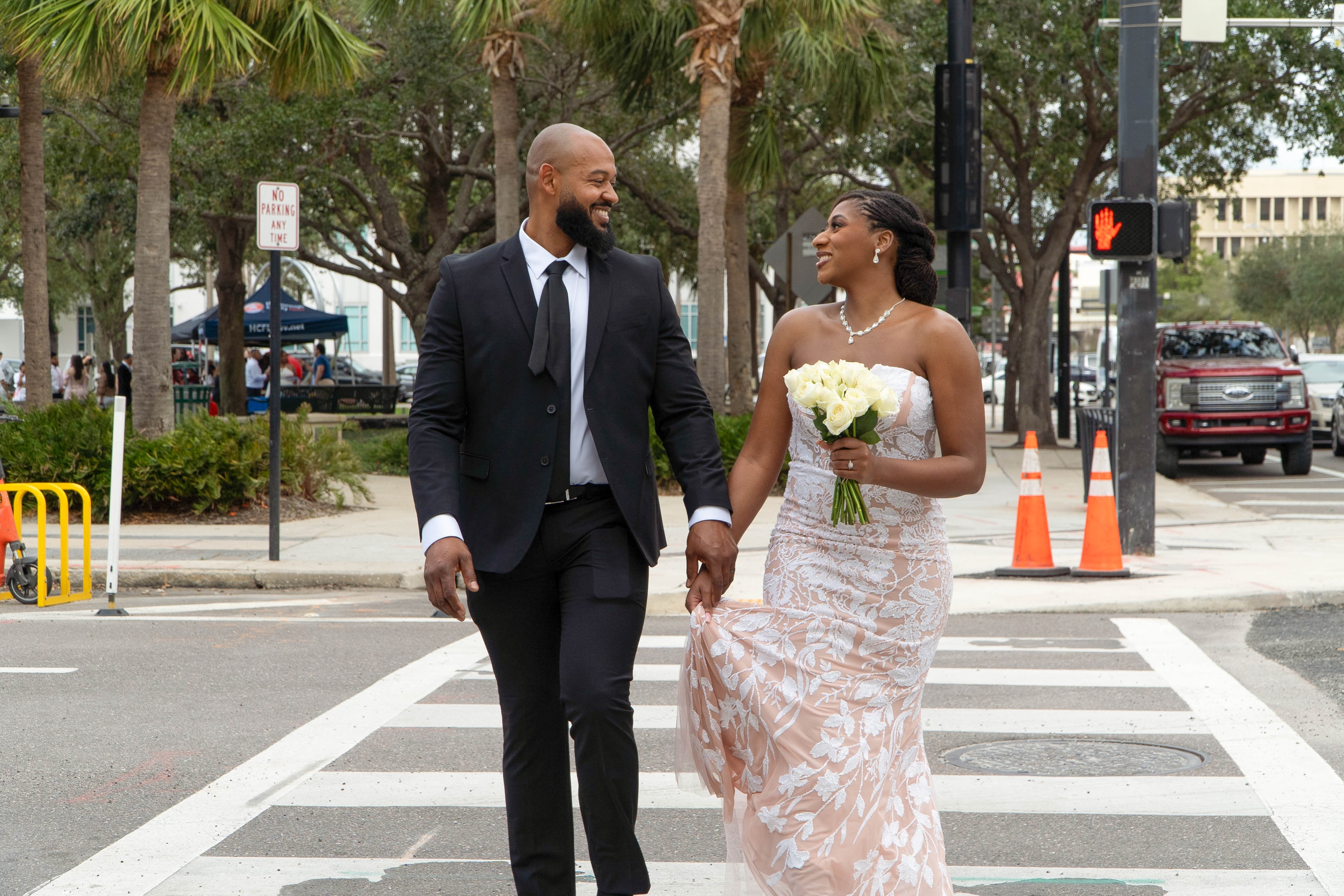 Couple laughing while crossing the street