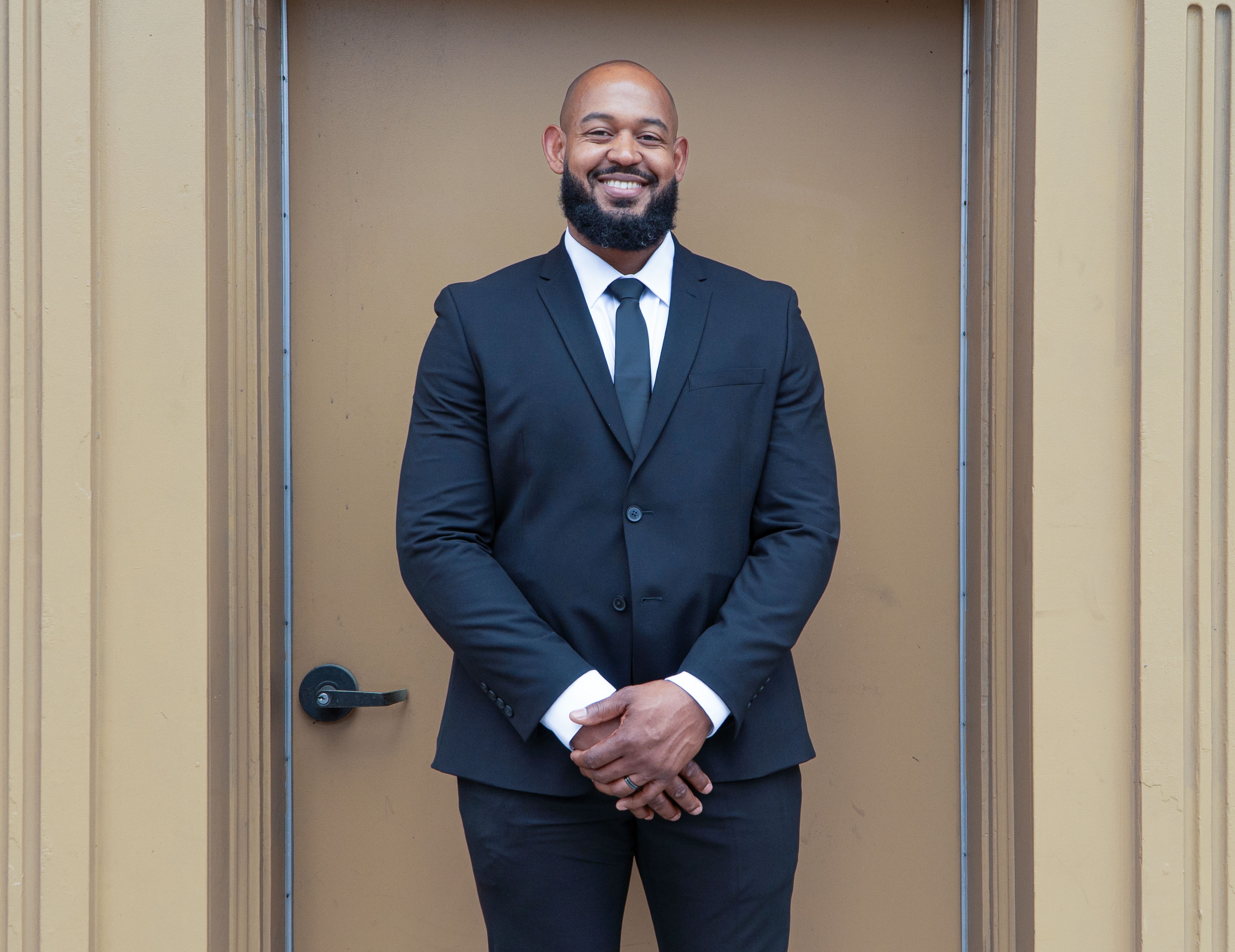 Groom portrait smiling in doorway