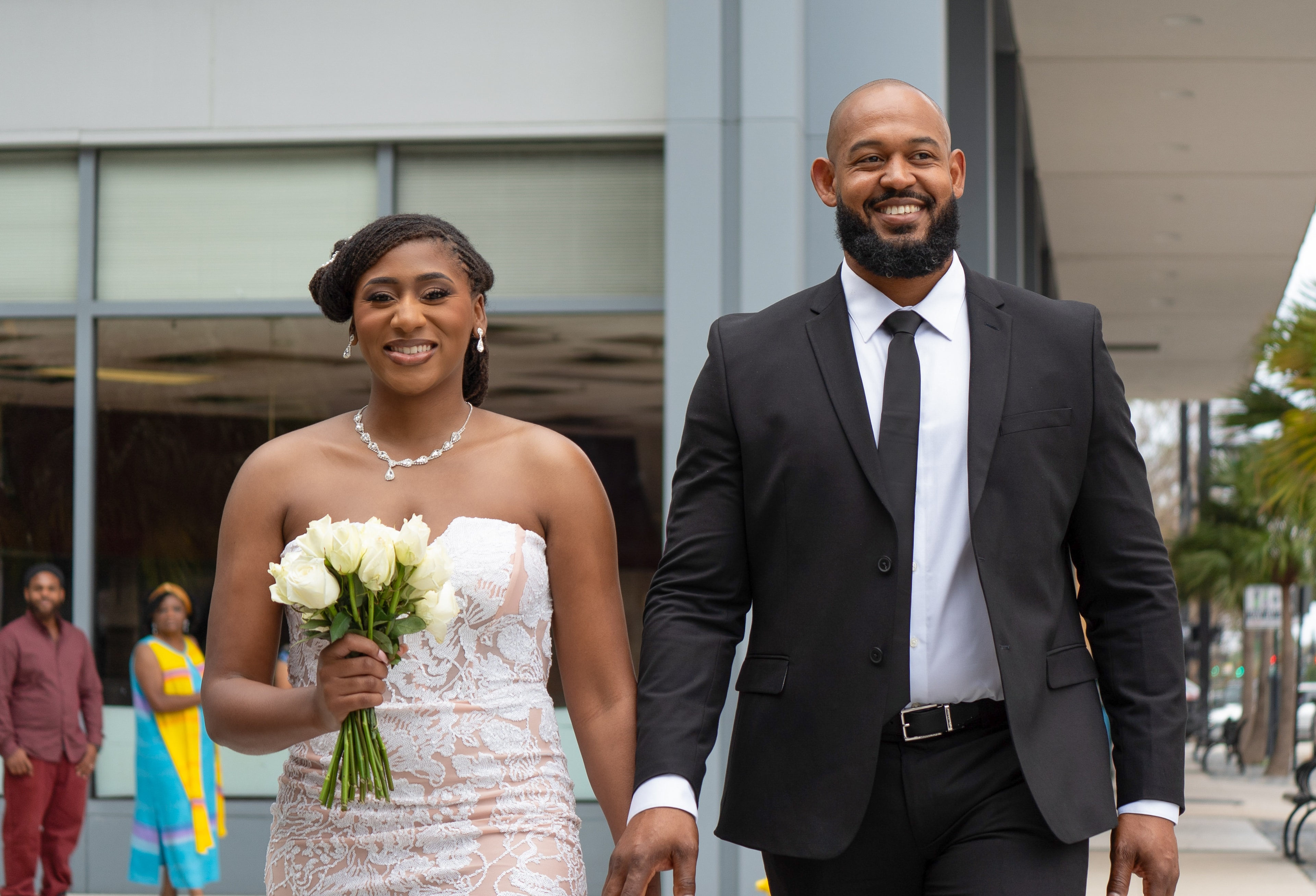 Bride and groom walking together smiling