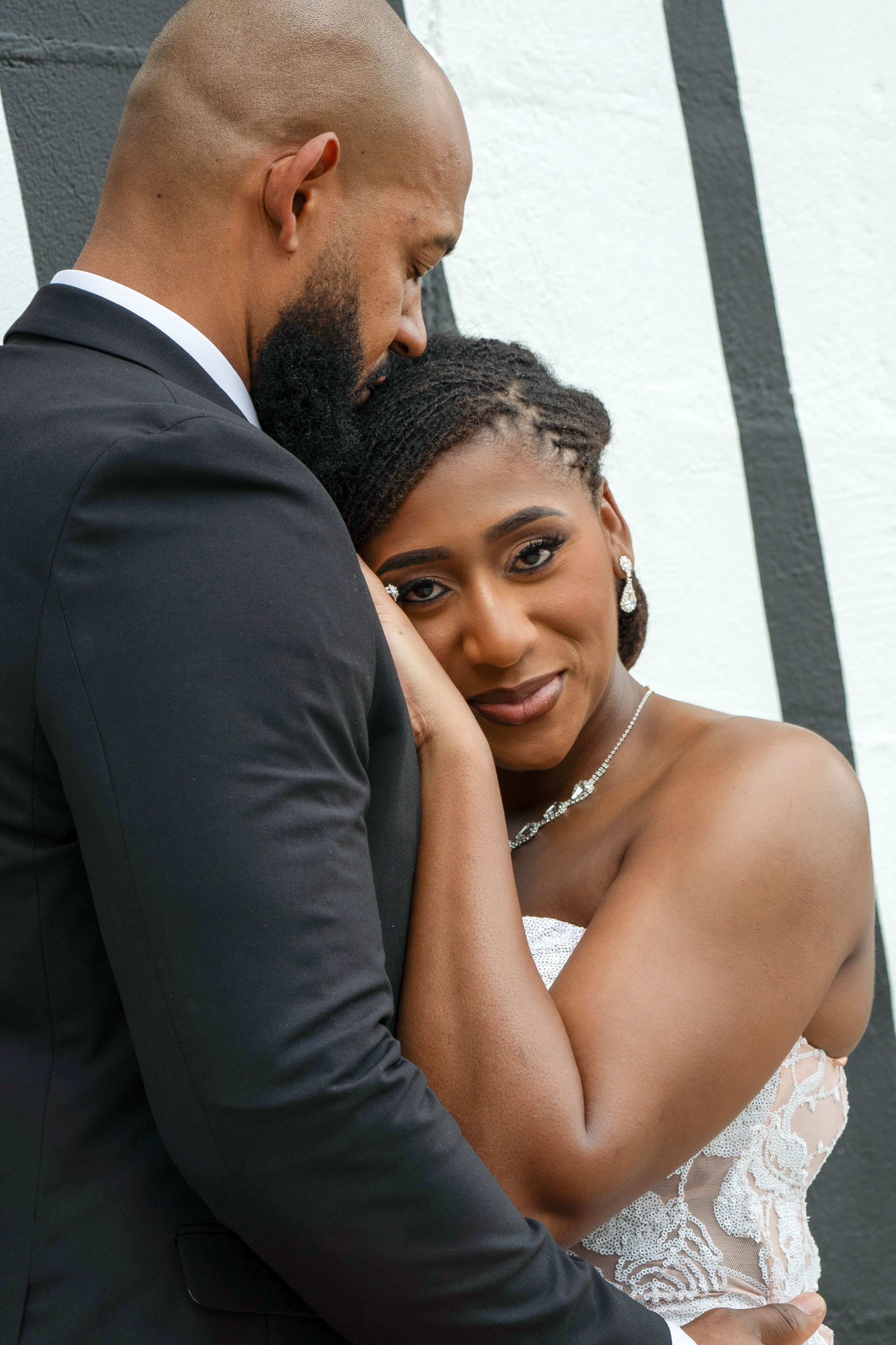 Intimate close portrait of bride resting on groom
