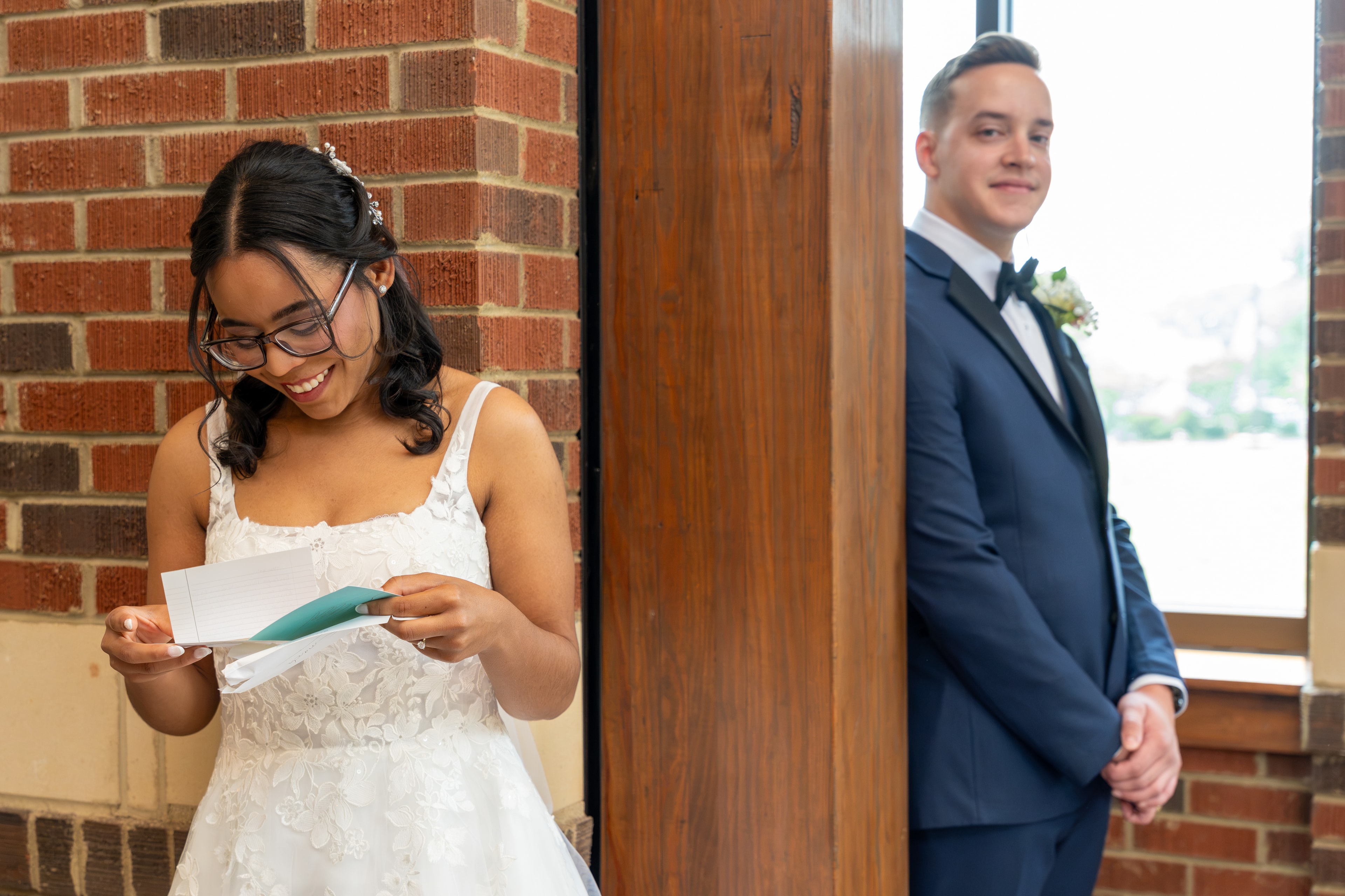 Bride smiling while reading a letter from the groom before the ceremony