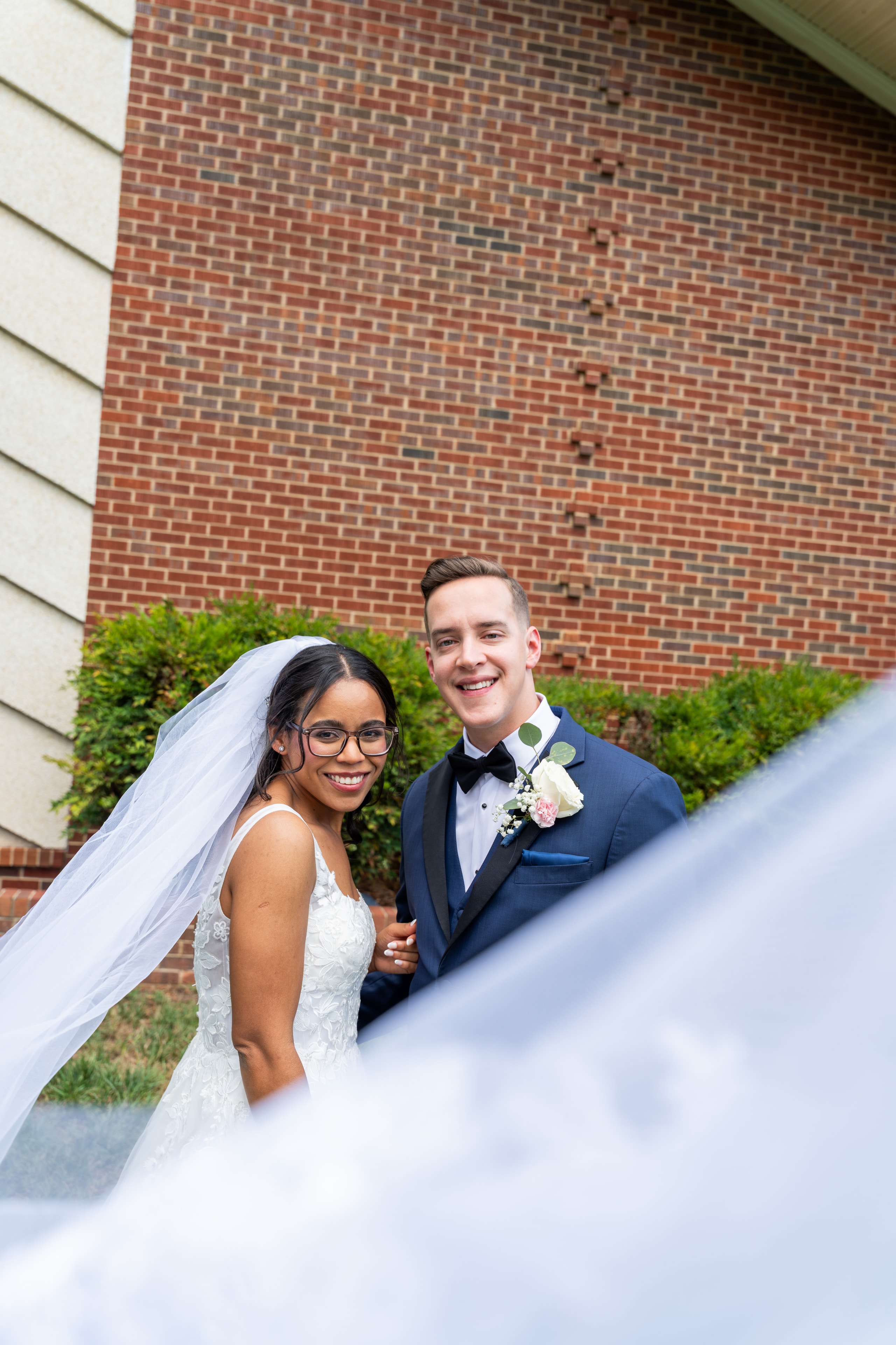 Bride and groom smiling together outside the church after the ceremony